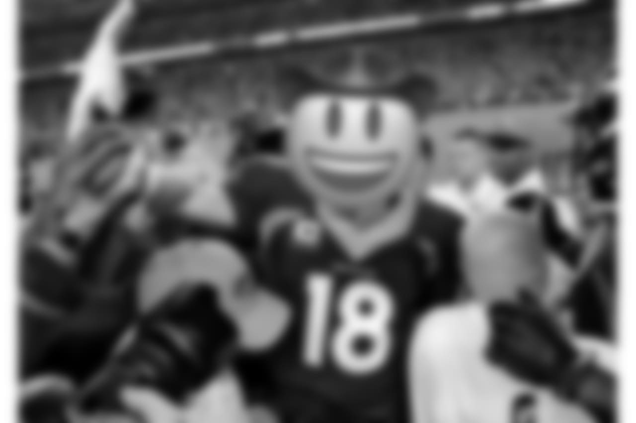 509: Peyton Manning celebrates with teammates after setting the career passing touchdowns record.
