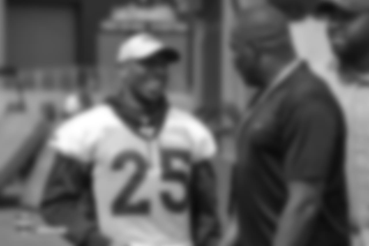 Cornerback Chris Harris Jr. (25) talks with Ring of Fame former wide receiver Rod Smith and former Bronco Kevin Vickerson during the 10th day of training camp on August 8, 2018, at UCHealth Training Center.