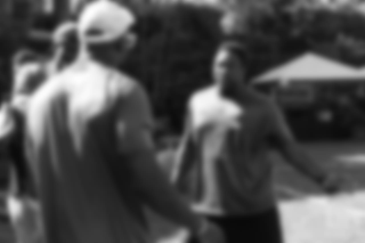 Warren Sapp gives instruction to Von Miller during the on-field portion of Von Miller's Pass Rush Summit, which included hands-on instruction and drills, on June 28, 2018.