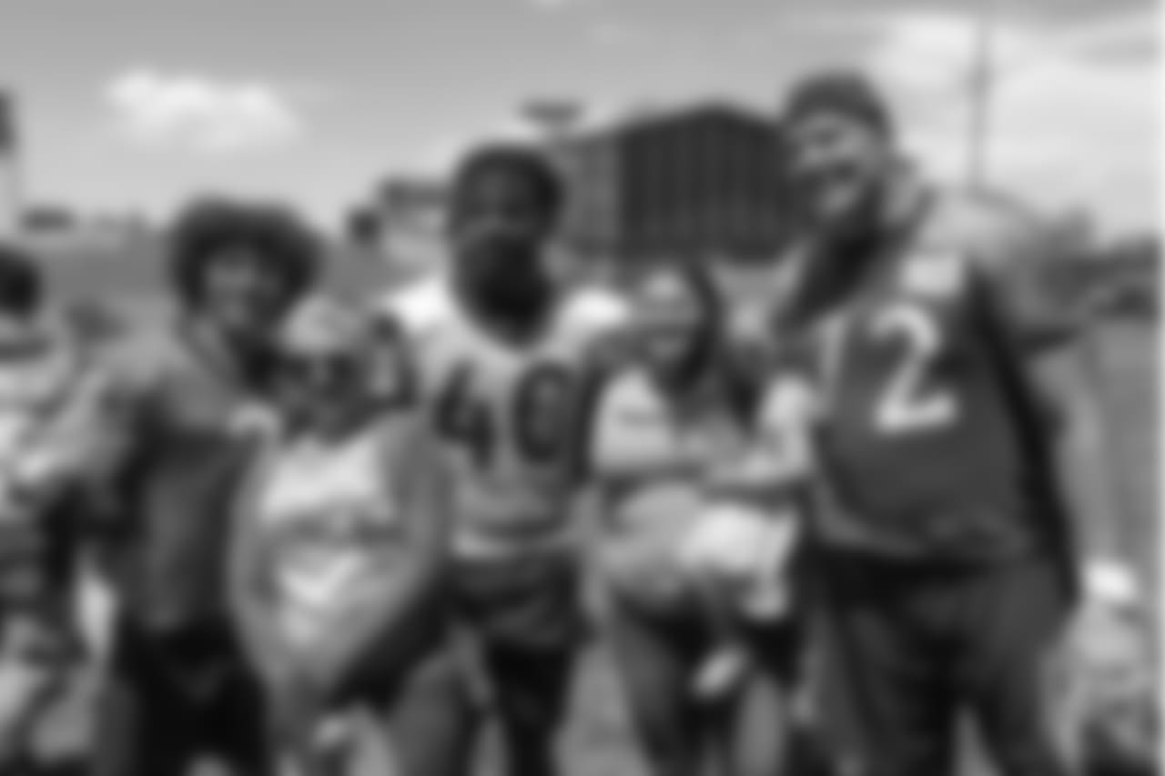 running back Phillip Lindsay (2), inside linebacker Keishawn Bierria (40) and tackle Garett Bolles (72) meet patients from Children's Hospital Colorado's burn unit after the final day of OTAs on June 7, 2018 at UCHealth Training Center.