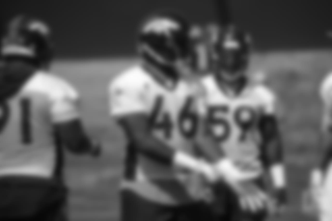 outside linebacker Jeff Holland (46) pulls his gloves on at the ninth day of OTAs on June 6, 2018 at UCHealth Training Center.