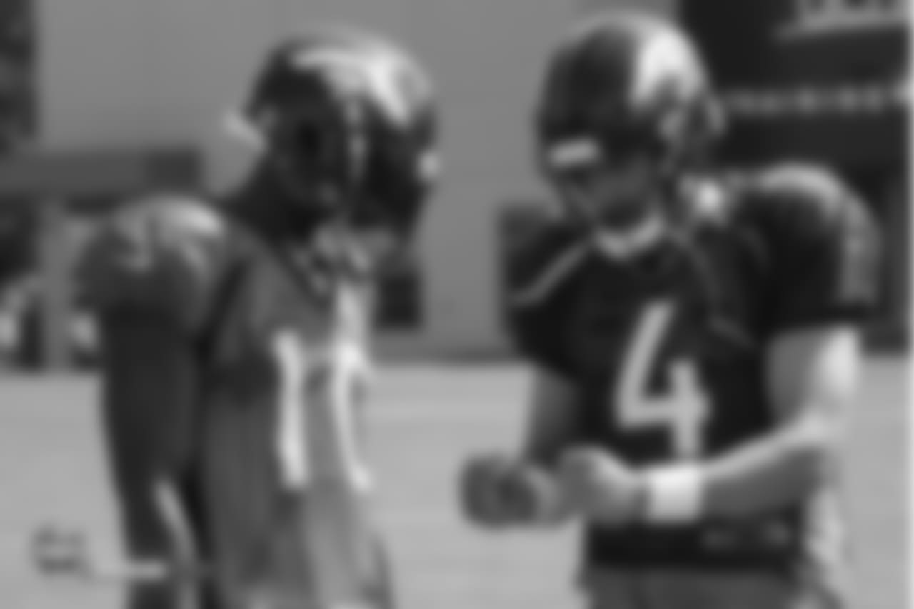 Quarterback Case Keenum (4) speaks with wide receiver Emmanuel Sanders (10) during the seventh day of training camp on August 4, 2018, at UCHealth Training Center.