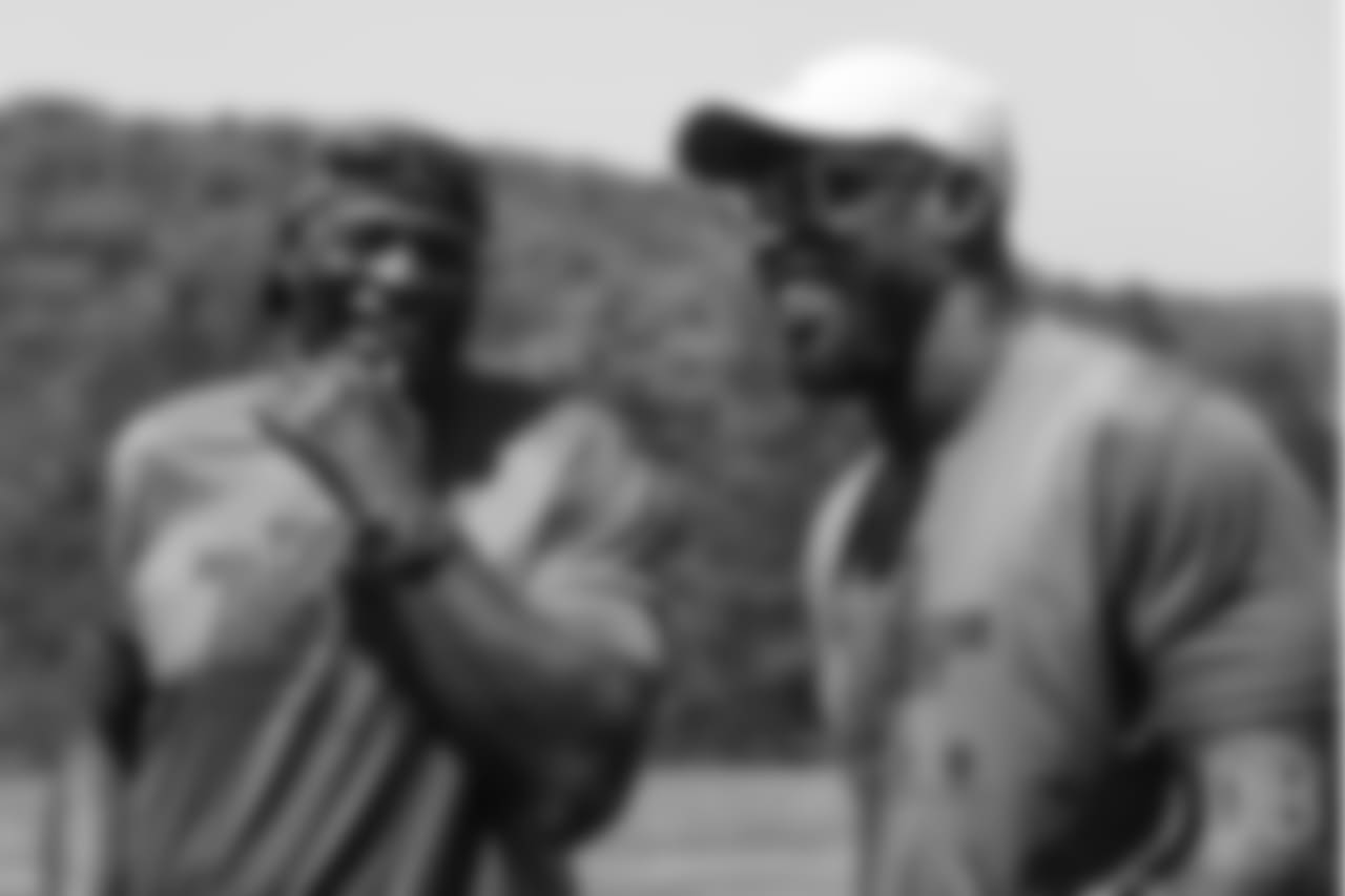 Bruce Smith and Von Miller share a laugh at the on-field portion of Von Miller's Pass Rush Summit, which included hands-on instruction and drills, on June 28, 2018.