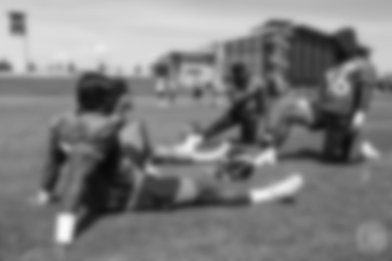 running back Royce Freeman (37), running back Phillip Lindsay (2), running back De'Angelo Henderson Sr. (33) and running back David Williams (36) stretch before the ninth day of OTAs on June 6, 2018 at UCHealth Training Center.