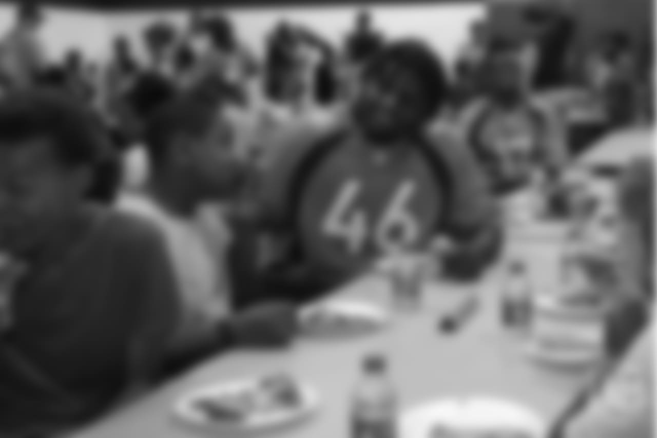 Outside linebacker Jeff Holland (46) sits with kids at the Denver Broncos Boys & Girls Club at the Broncos' third annual Rookie Community Service Day on June 11, 2018.