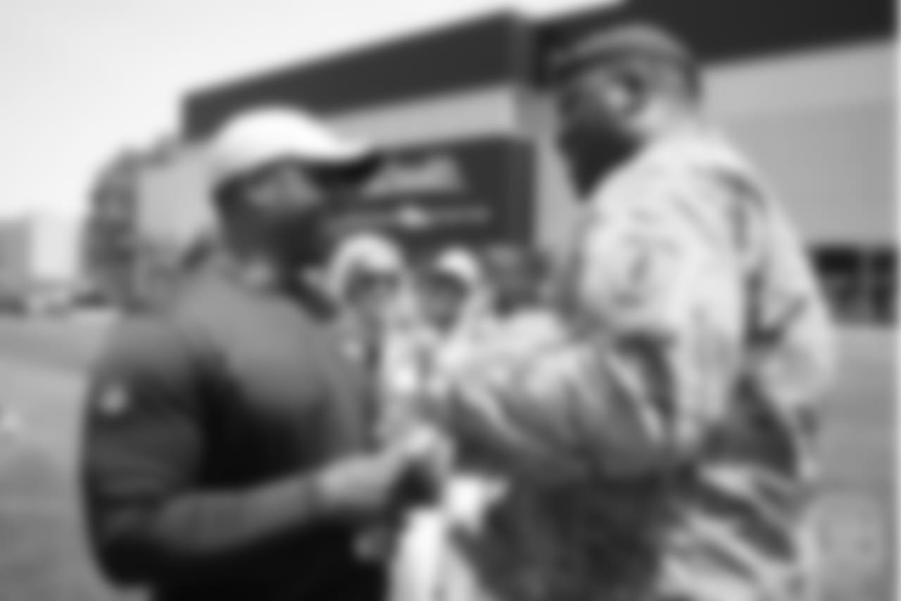 Head Coach Vance Joseph greets U.S. Army chaplain Darius Holland after practice on June 12, 2018. Holland and Joseph are friends and were teammates during their days on the Colorado Buffaloes football team. The meet-and-greet with Holland and other members of the Army and Colorado Air National Guard was part of an event hosting servicemen and servicewomen with USAA and the Broncos Womens Organization.
Photo by Gabriel Christus