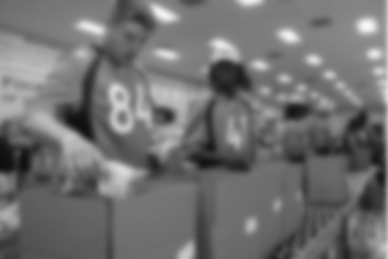 Tight end Troy Fumagalli (84) and cornerback Isaac Yiadom (41) put together food packages at the Food Bank of the Rockies at the Broncos' third annual Rookie Community Service Day on June 11, 2018.