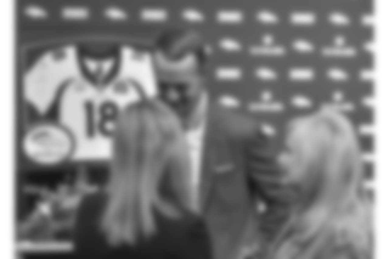 Peyton Manning speaks with Annabel Bowlen after his retirement ceremony at UCHealth Training Center on March 7, 2016.