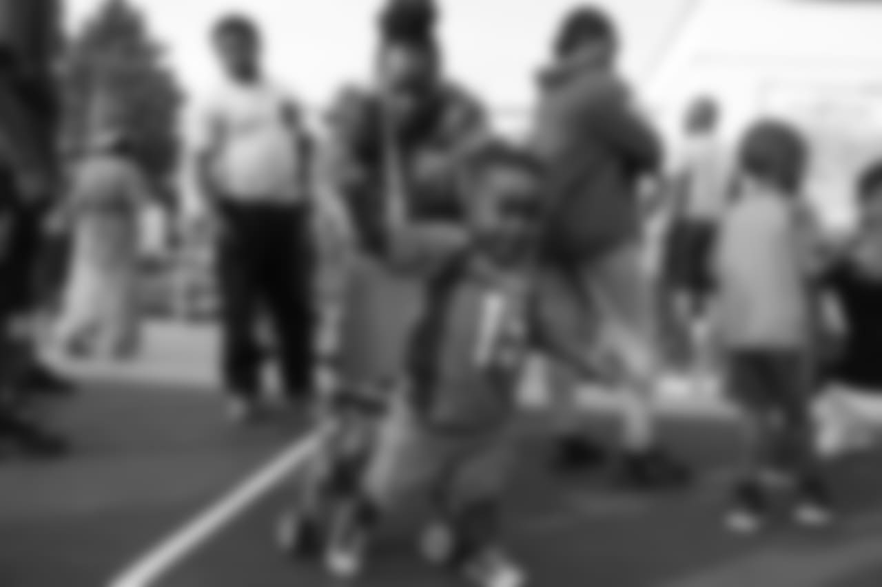 A toddler gets up out of his stroller at the Denver Broncos Boys & Girls Club's 15th anniversary celebration on August 2, 2018.