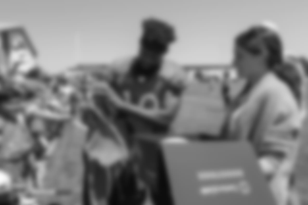 Wide receiver Emmanuel Sanders (10) pulls his jersey out of a CenturyLink Boostbox filled his memorabilia after the 11th day of training camp on August 9, 2018, at UCHealth Training Center. Sanders autographed the jersey and other items from the box and gave them to fans.