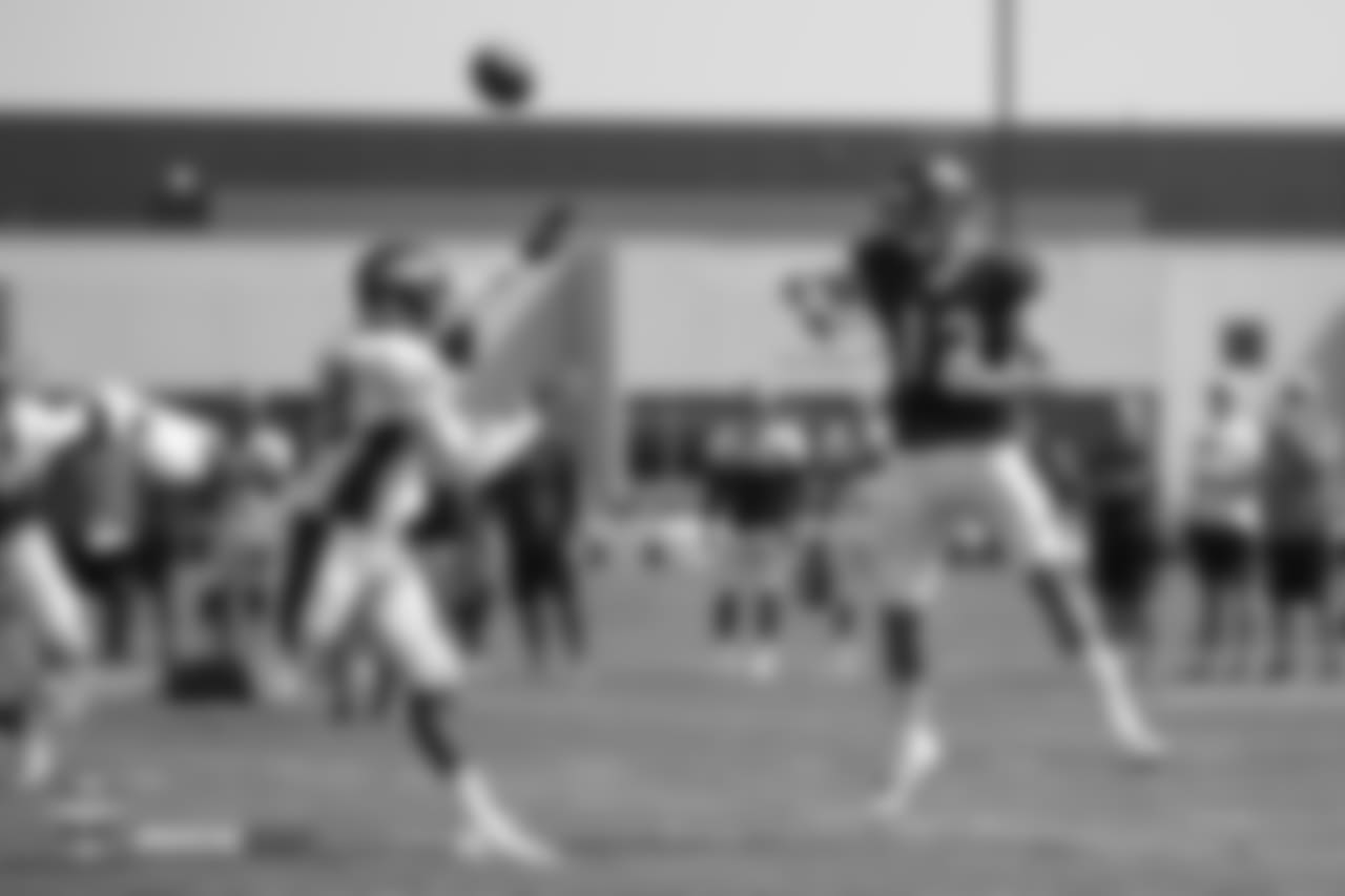 Quarterback Paxton Lynch (12) throws over outside linebacker Shaquil Barrett (48) during the ninth day of training camp on August 7, 2018, at UCHealth Training Center.