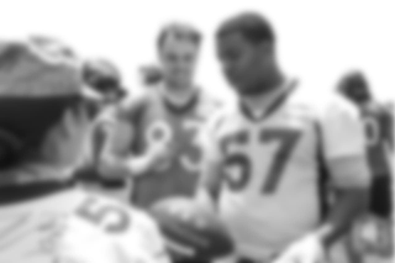 Tight end Matt LaCosse (83) and defensive end DeMarcus Walker (57) meet military members of the Colorado Air National Guard and the U.S. Army after practice on June 12, 2018. The meet-and-greet was part of an event hosting servicemen and servicewomen with USAA and the Broncos Womens Organization.