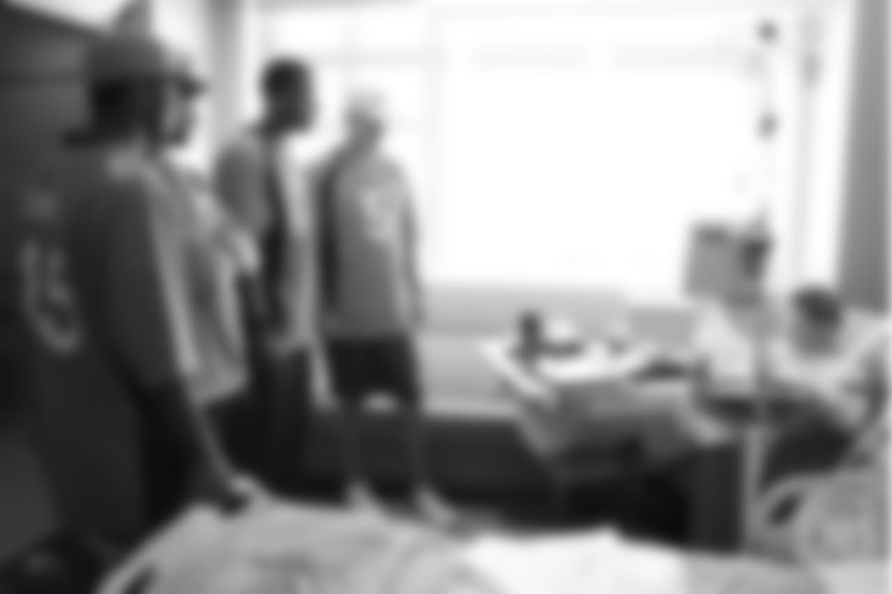 Wide receiver Jimmy Williams (85), wide receiver DaeSean Hamilton (17), wide receiver Courtland Sutton (14) and quarterback Nick Stevens (5) meet a patient at UCHealth's University of Colorado Hospital at the Broncos' third annual Rookie Community Service Day on June 11, 2018.