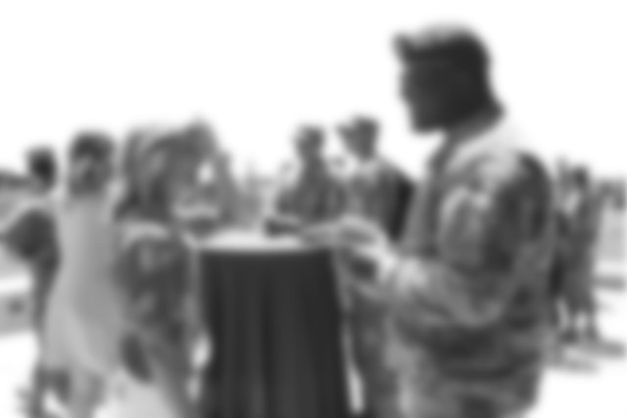 Holly Joseph meets military members of the Colorado Air National Guard and the U.S. Army during practice on June 12, 2018. The meet-and-greet was part of an event hosting servicemen and servicewomen with USAA and the Broncos Womens Organization. The man in the beret is former Colorado Buffaloes football player Darius Holland, a former teammate of Holly's husband, Head Coach Vance Joseph.