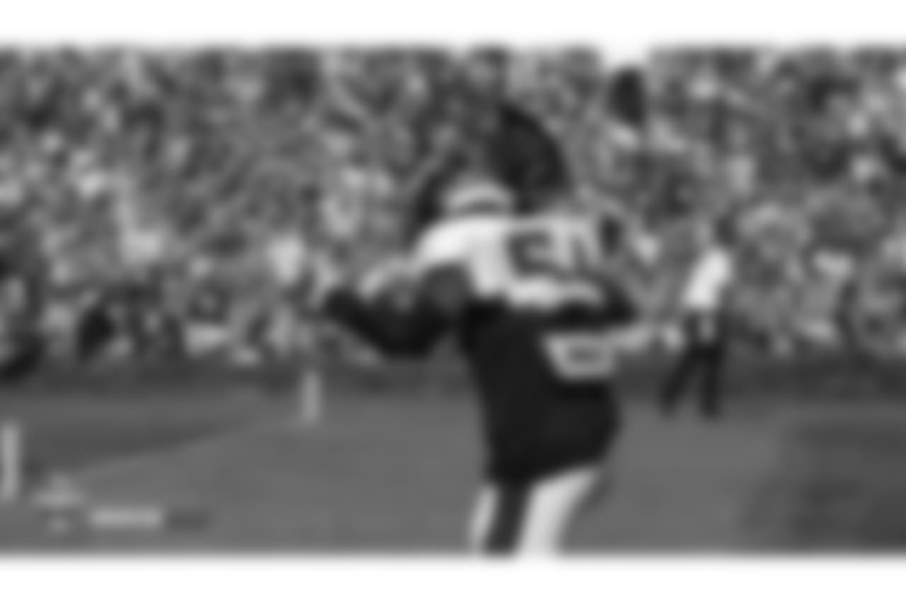 Inside linebacker Brandon Marshall (54) runs out to the field, waving a towel for Alzheimer's Awareness Day, during the seventh day of training camp on August 4, 2018, at UCHealth Training Center.