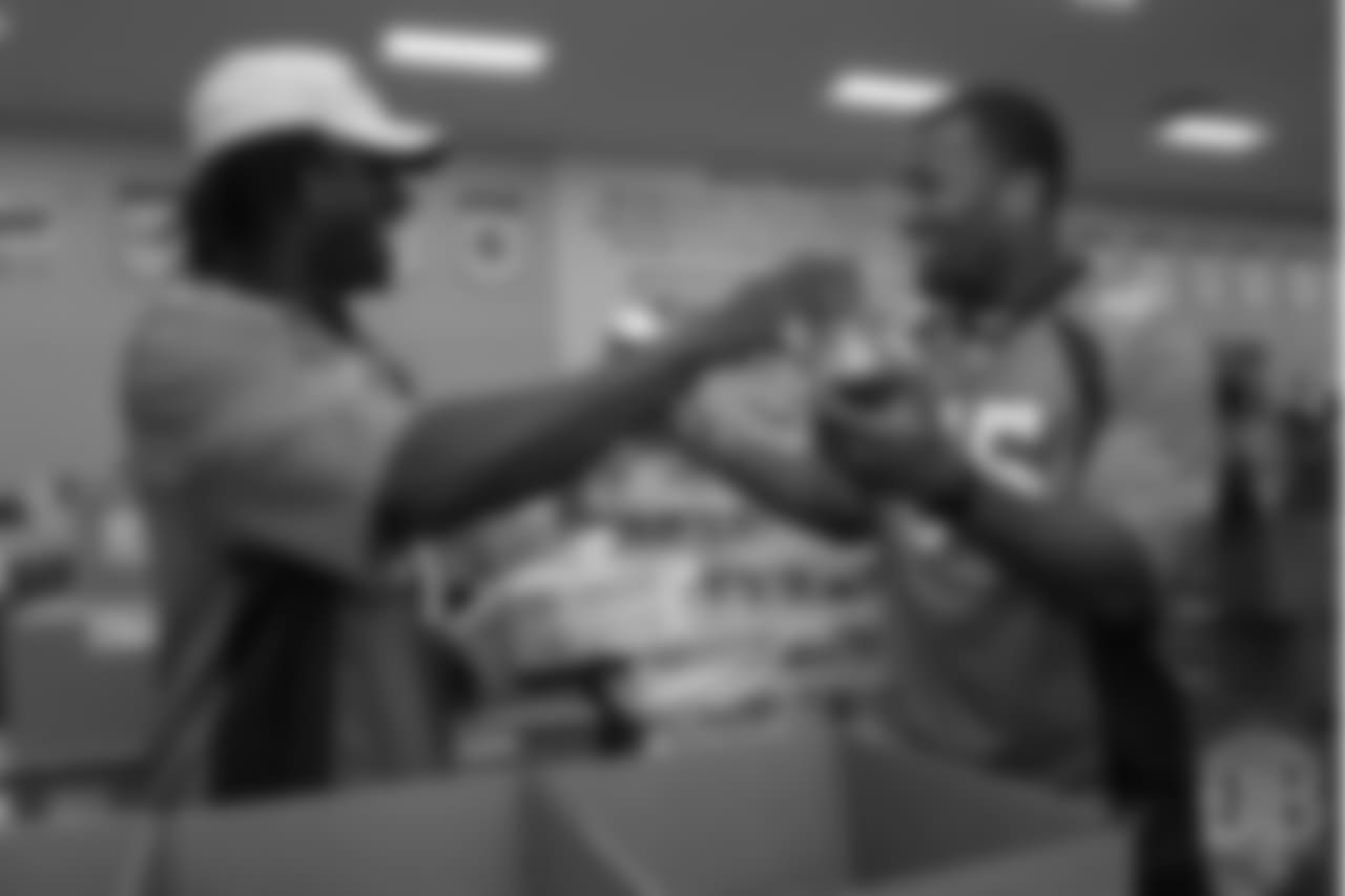 Cornerback Isaac Yiadom (41) and outside linebacker Bradley Chubb (55) laugh while packing food at the Food Bank of the Rockies at the Broncos' third annual Rookie Community Service Day on June 11, 2018.