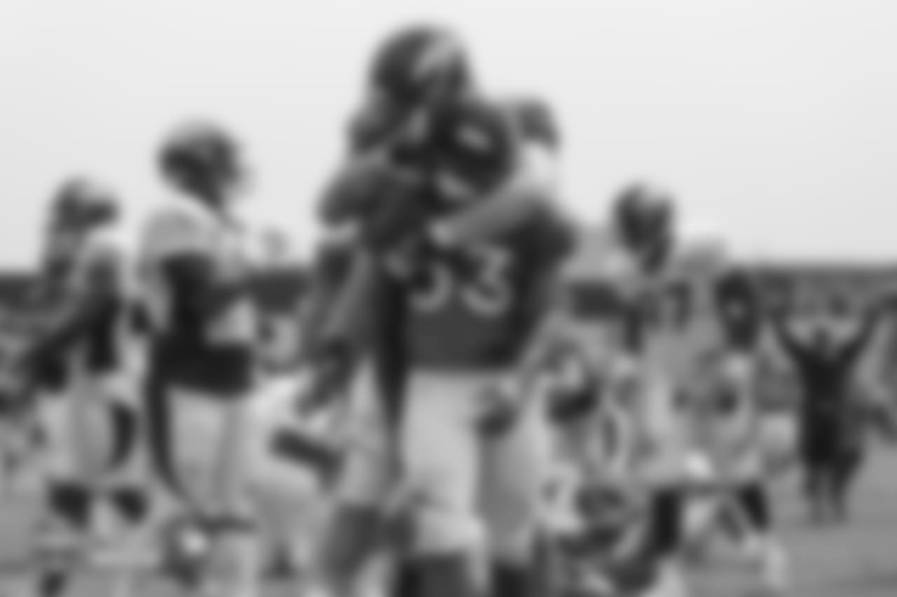 Tackle Andreas Knappe (73) hugs running back De'Angelo Henderson Sr. (33) after a touchdown at the sixth day of training camp on August 3, 2018, at UCHealth Training Center.
