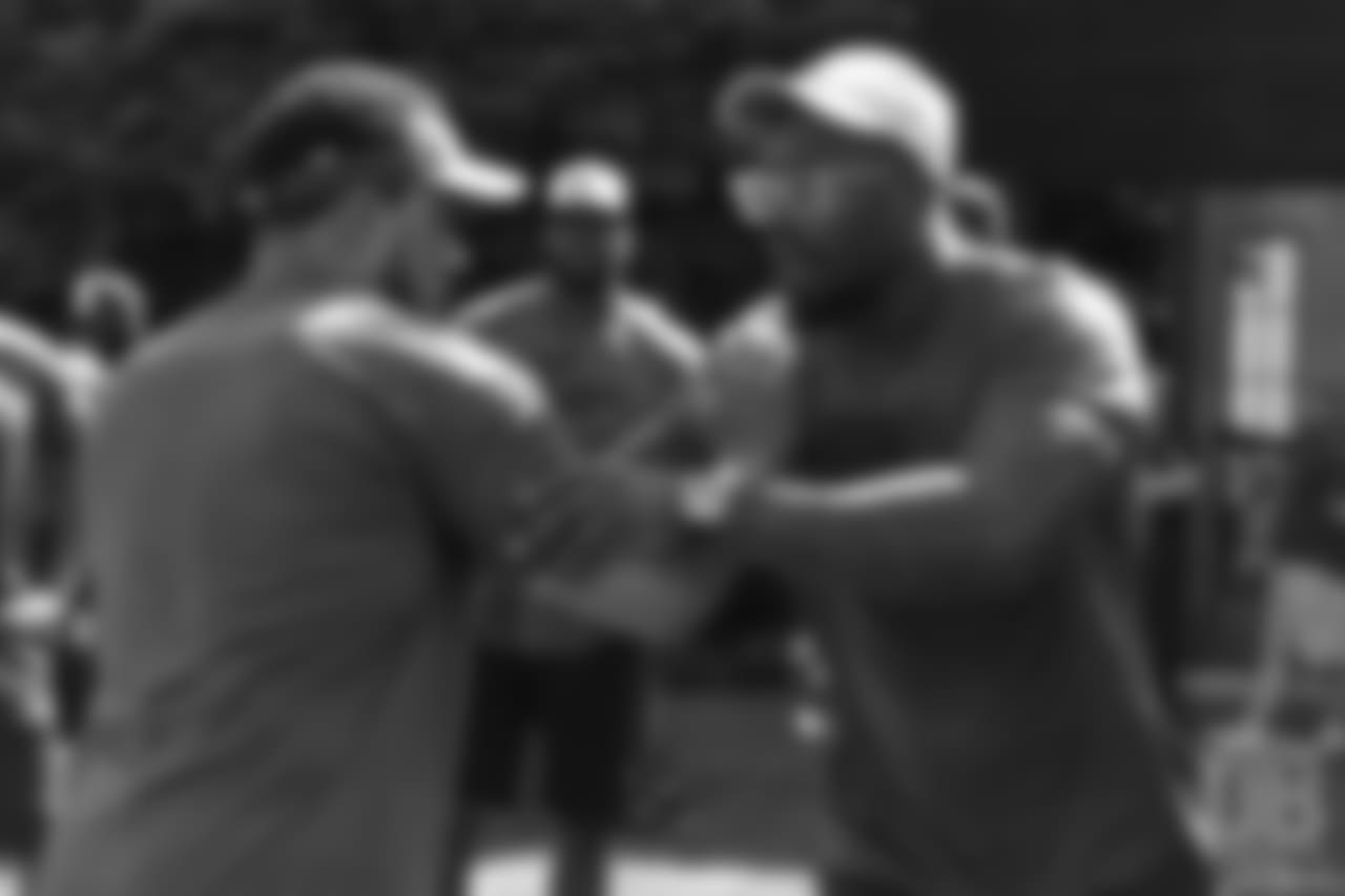 Pass rush coach Chuck Smith gives instruction to Von Miller during the on-field portion of Von Miller's Pass Rush Summit, which included hands-on instruction and drills, on June 28, 2018.