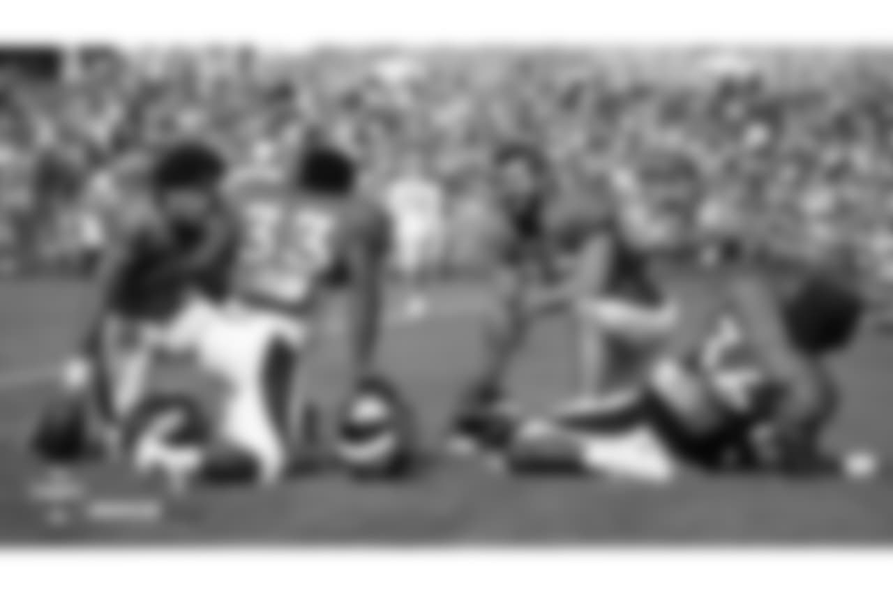 Running back Phillip Lindsay (2), running back De'Angelo Henderson Sr. (33), fullback Andy Janovich (32) and running back Dave Williams (36) relax before the fifth day of training camp on August 1, 2018, at UCHealth Training Center.
