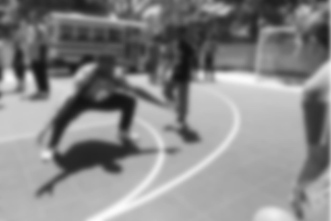 Wide receiver John Diarse (9) defends a kid in a basketball game at the Denver Broncos Boys & Girls Club at the Broncos' third annual Rookie Community Service Day on June 11, 2018.