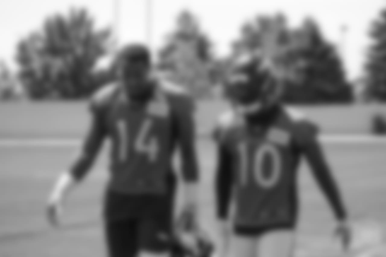 wide receiver Courtland Sutton (14) talks with wide receiver Emmanuel Sanders (10) at the ninth day of OTAs on June 6, 2018 at UCHealth Training Center.