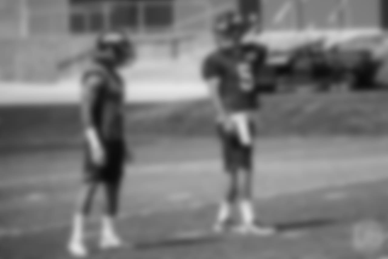 quarterback Nick Stevens (5) checks the call with running back Phillip Lindsay (2) in the backfield at the ninth day of OTAs on June 6, 2018 at UCHealth Training Center.