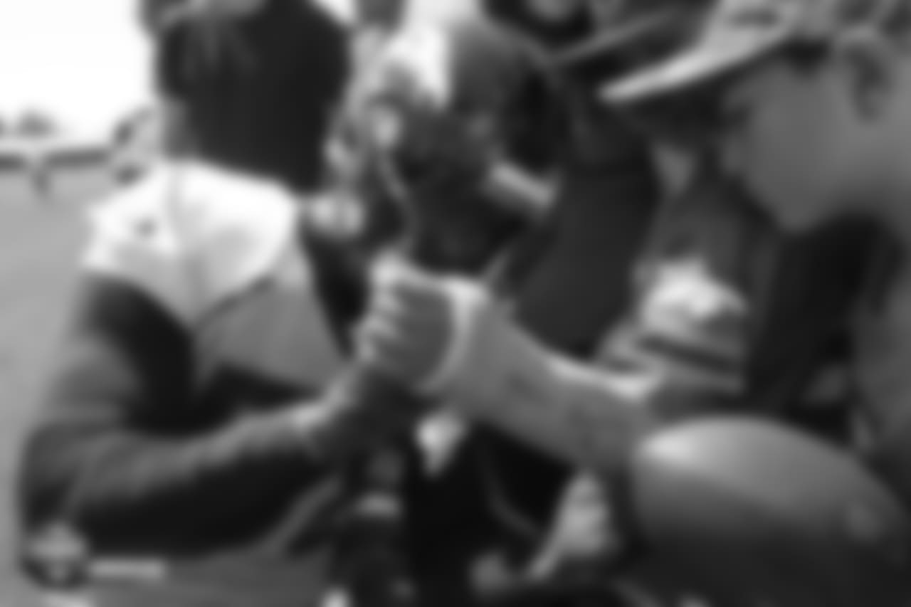 Outside linebacker Von Miller (58) signs a boy's cast after the 11th day of training camp on August 9, 2018, at UCHealth Training Center.