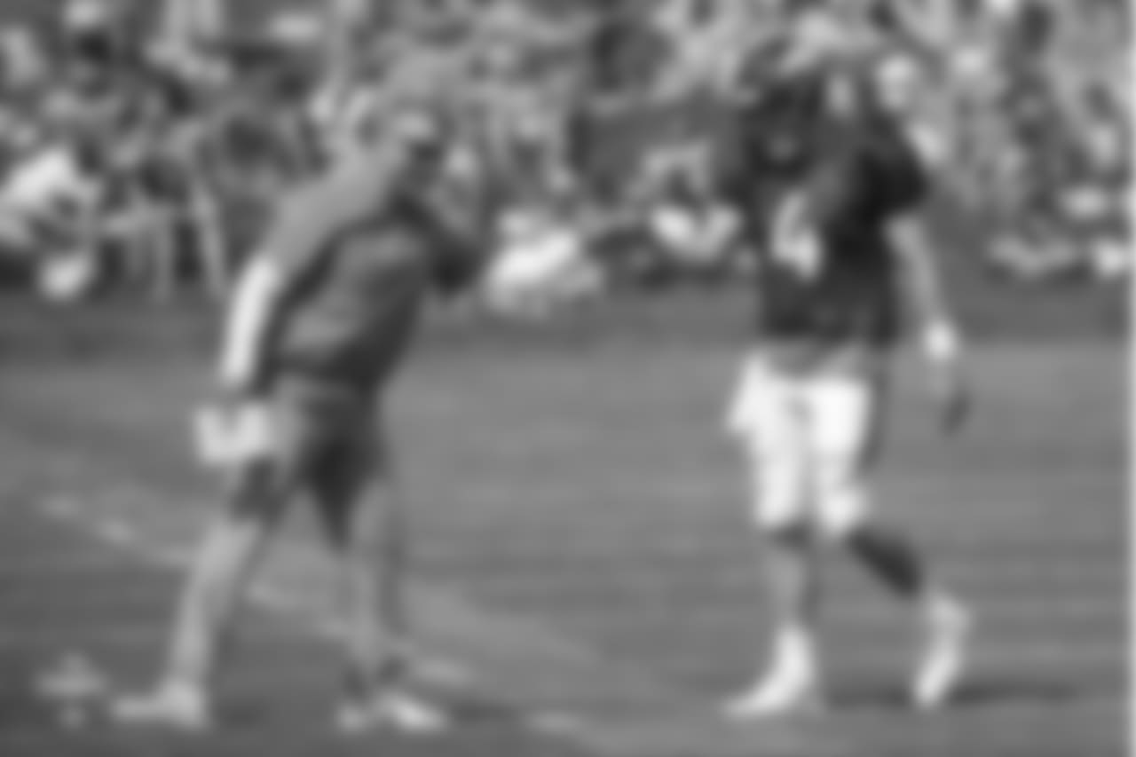 Quarterback Case Keenum (4) and Quarterbacks Coach Mike Sullivan fist bump during the ninth day of training camp on August 7, 2018, at UCHealth Training Center.