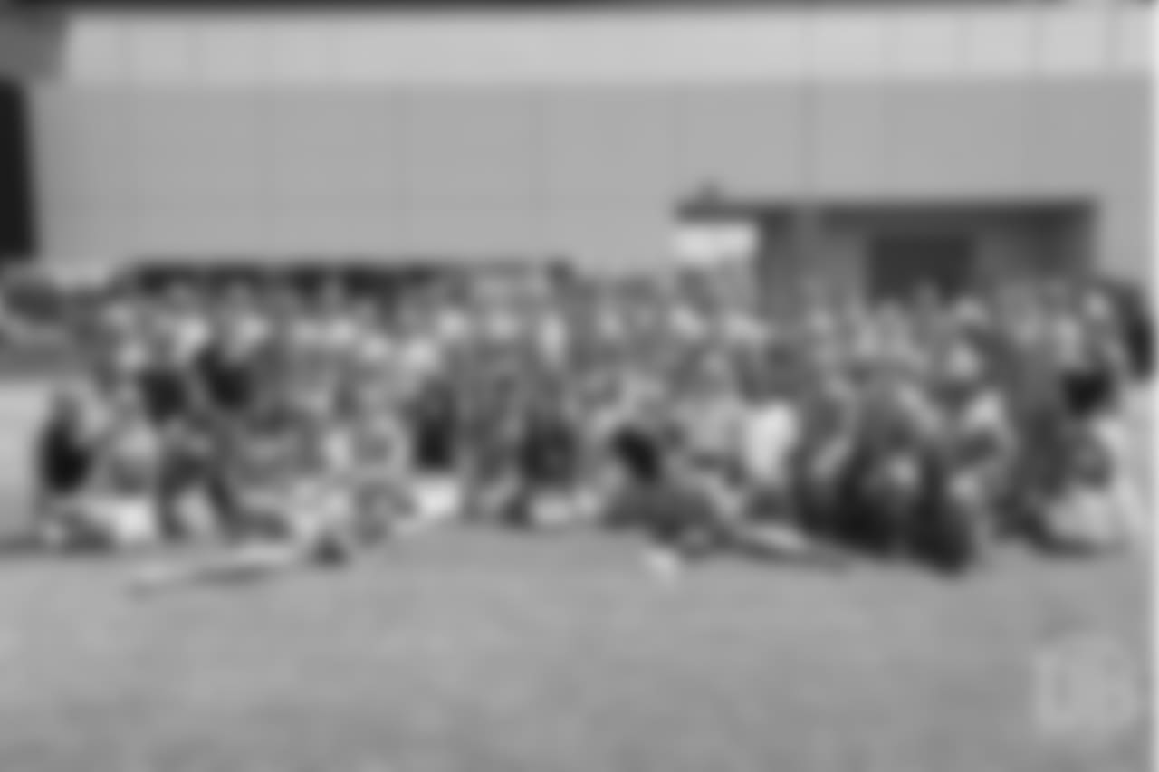 A group photo of military members of the Colorado Air National Guard and the U.S. Army after practice on June 12, 2018. The meet-and-greet was part of an event hosting servicemen and servicewomen with USAA and the Broncos Womens Organization.