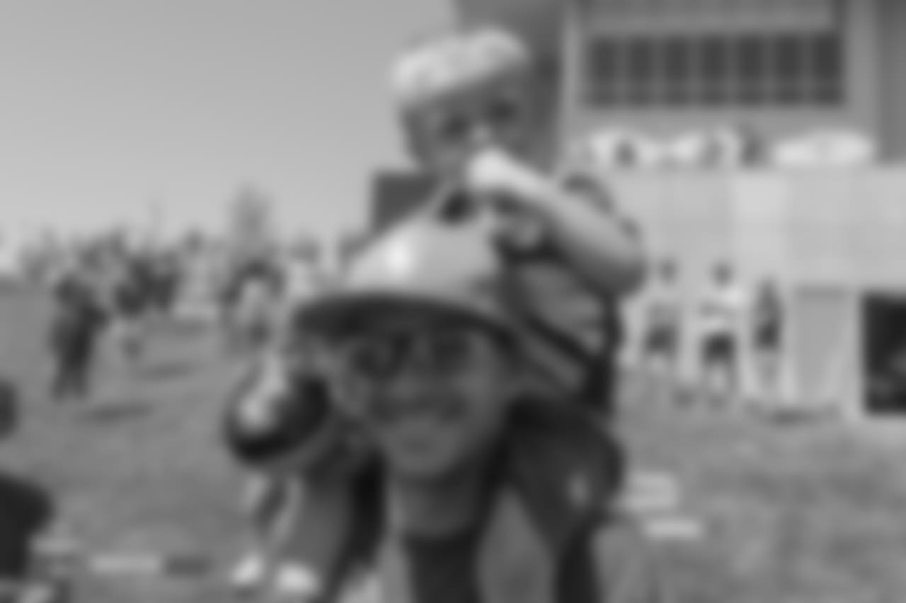 A young boy and his father after the 11th day of training camp on August 9, 2018, at UCHealth Training Center.