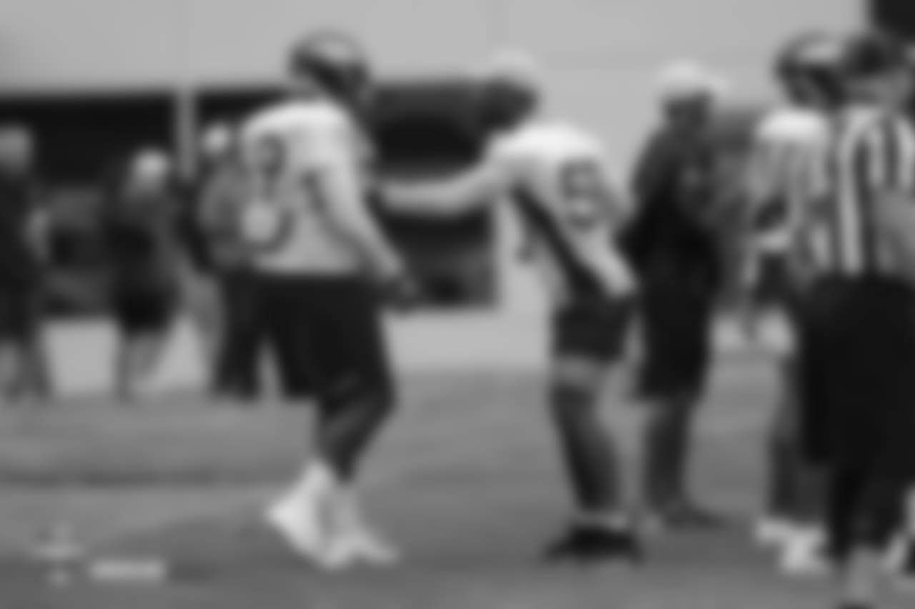 Defensive end Antonio Simmons (69) works with outside linebacker Von Miller (58) during the 10th day of training camp on August 8, 2018, at UCHealth Training Center.