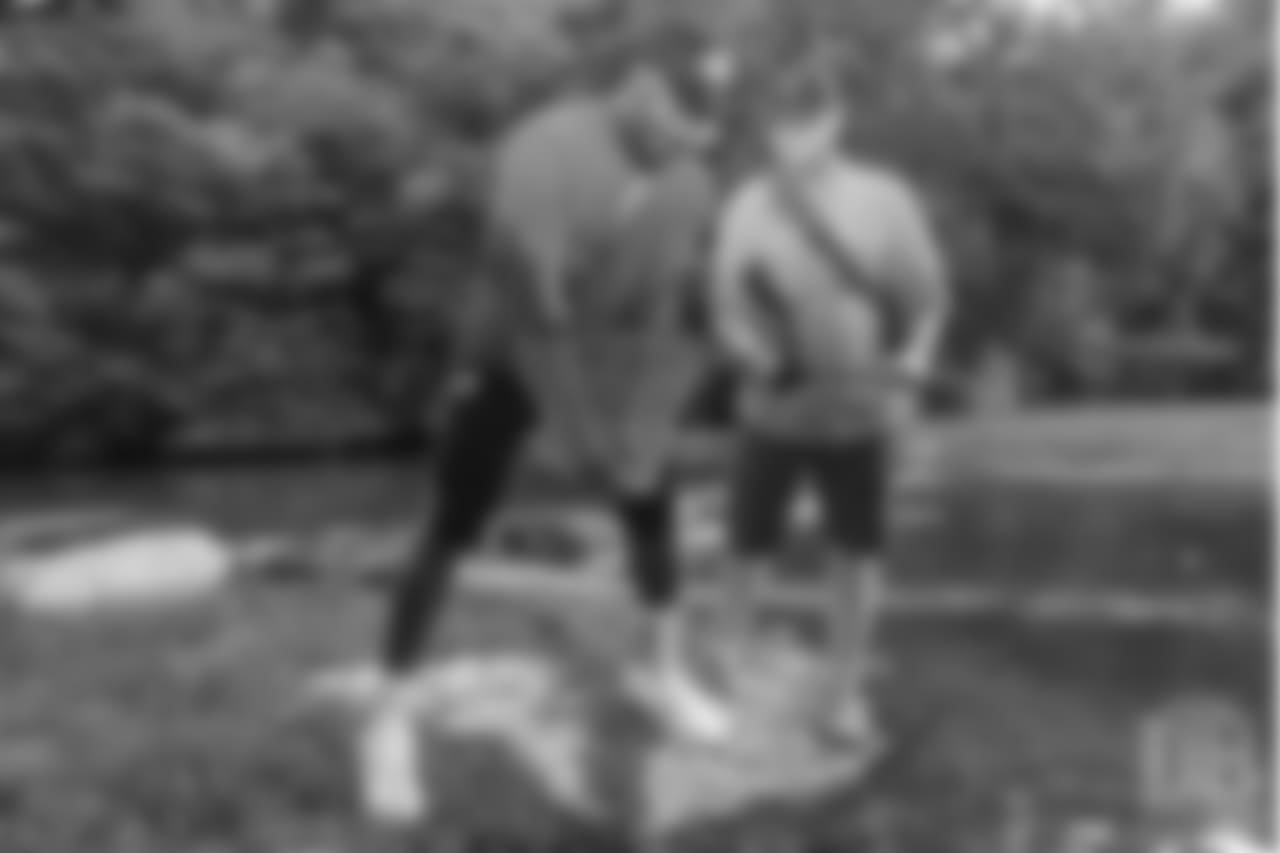 Von Miller picks up his catch at the fishing portion of Von Miller's Pass Rush Summit at Dogwood Canyon Nature Park on June 28, 2018.