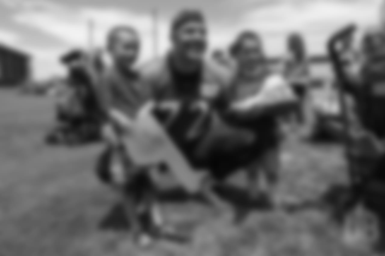 tackle Garett Bolles (72) poses for a photo with two children from Children's Hospital Colorado's burn unit after the final day of OTAs on June 7, 2018 at UCHealth Training Center. Bolles autographed a pair of shoes and gave them away.