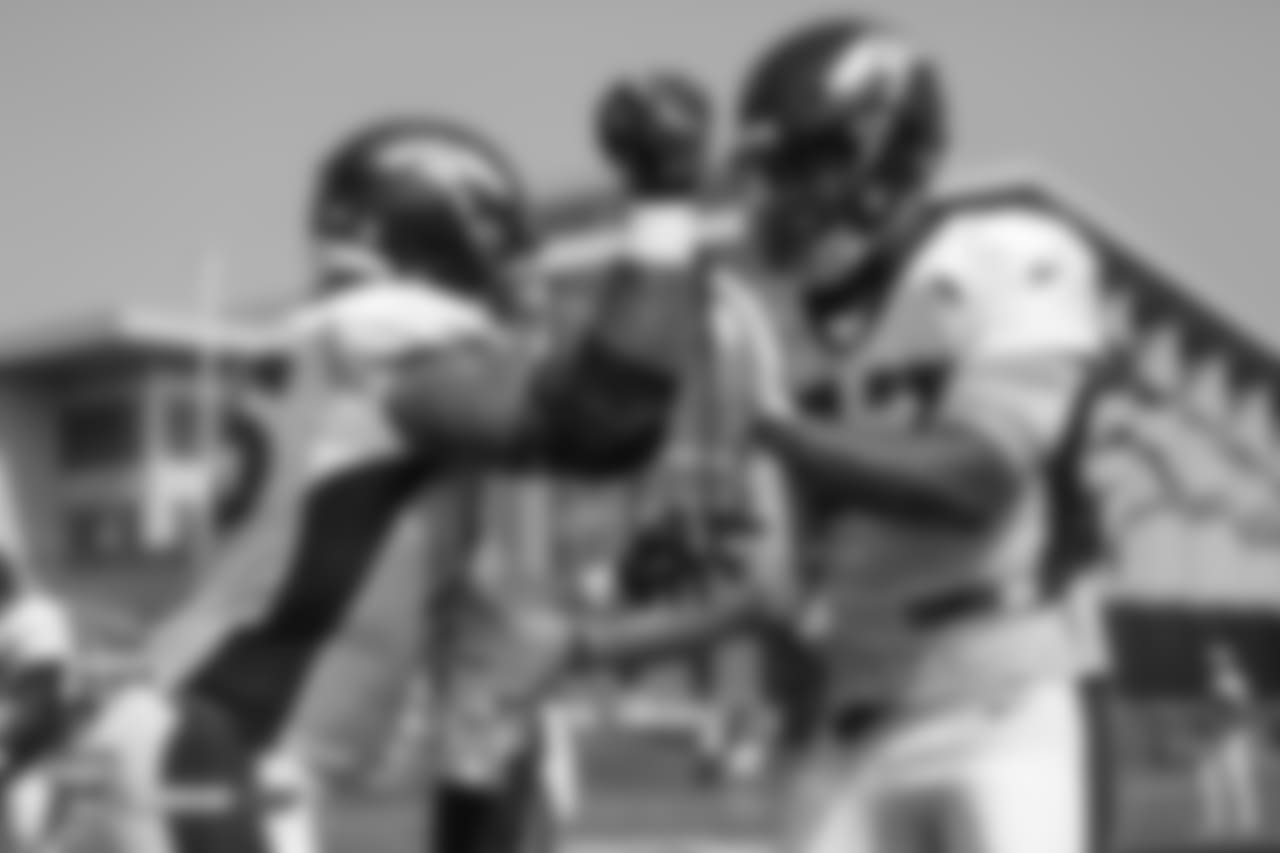 Defensive end Derek Wolfe (95) and defensive end DeMarcus Walker (57) during the ninth day of training camp on August 7, 2018, at UCHealth Training Center.