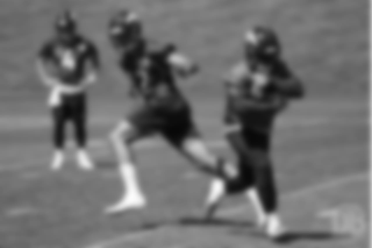 quarterback Paxton Lynch (12) hands the ball off to running back De'Angelo Henderson Sr. (33) during the 10th and final day of OTAs on June 7, 2018 at UCHealth Training Center.