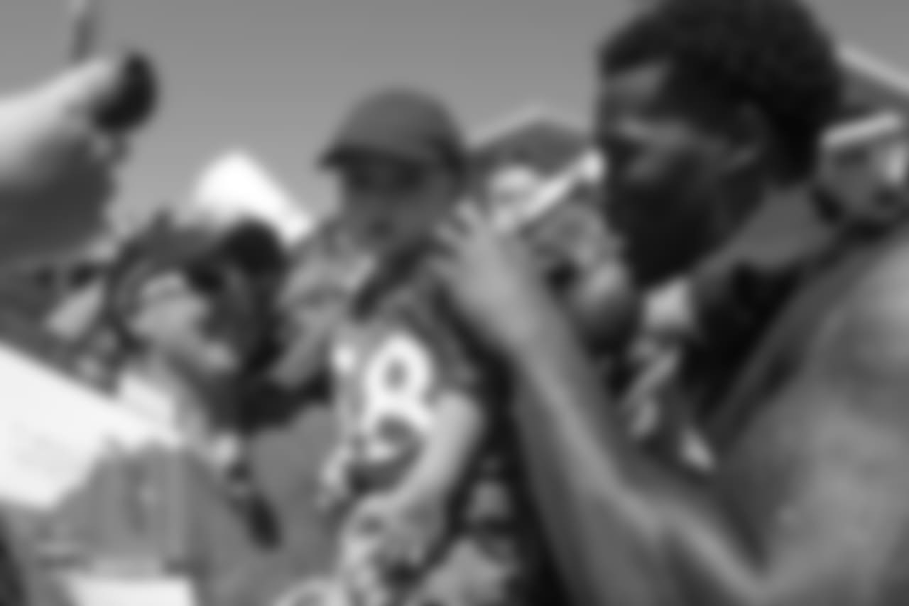 Wide receiver Demaryius Thomas (88) autographs a jersey a young boy is wearing after the 11th day of training camp on August 9, 2018, at UCHealth Training Center.