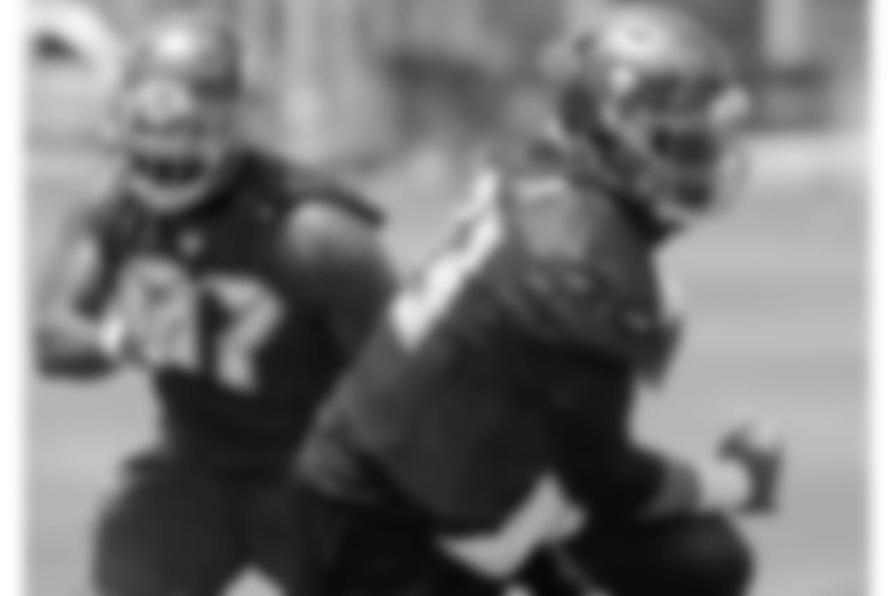 TAMPA, FLORIDA - MAY 24, 2018: Defensive Tackle Gerald McCoy #93 and Defensive End Vinny Curry #97 of the Tampa Bay Buccaneers during OTA practice at One Buccaneer Place. (Photo by Mike Carlson/Tampa Bay Buccaneers)