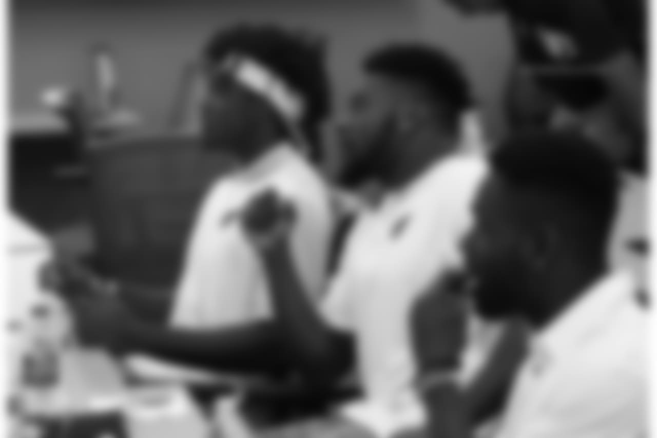 WR Chad Willams (left) and RB T.J. Logan listen to Sheriff Paul Penzone