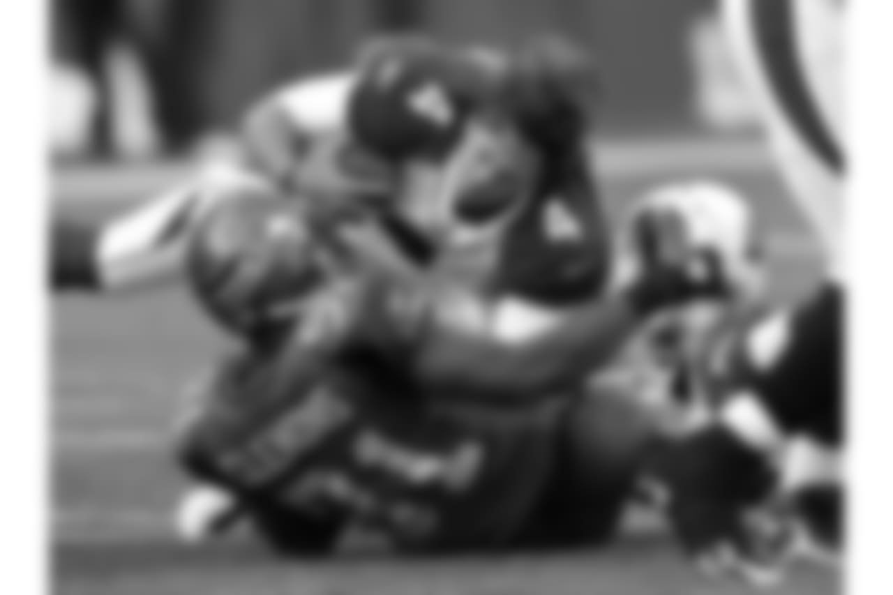 2011: QB Kevin Kolb is tackled by Seattle DE Chris Clemons and loses his helmet