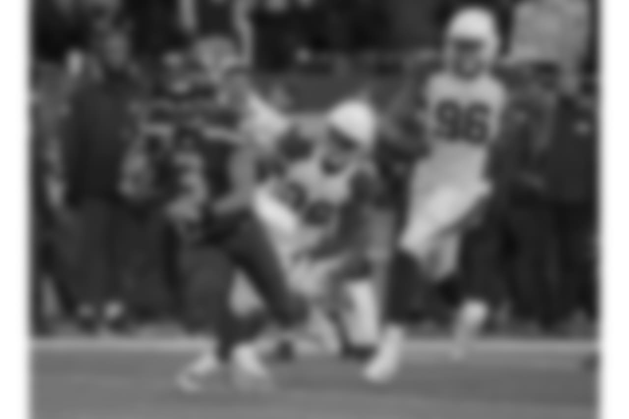 Seahawks QB Russell Wilson tries to escape from Cardinals S Budda Baker