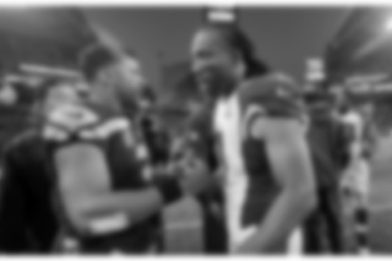 Russell Wilson (left) and Larry Fitzgerald (right) meet up after the game