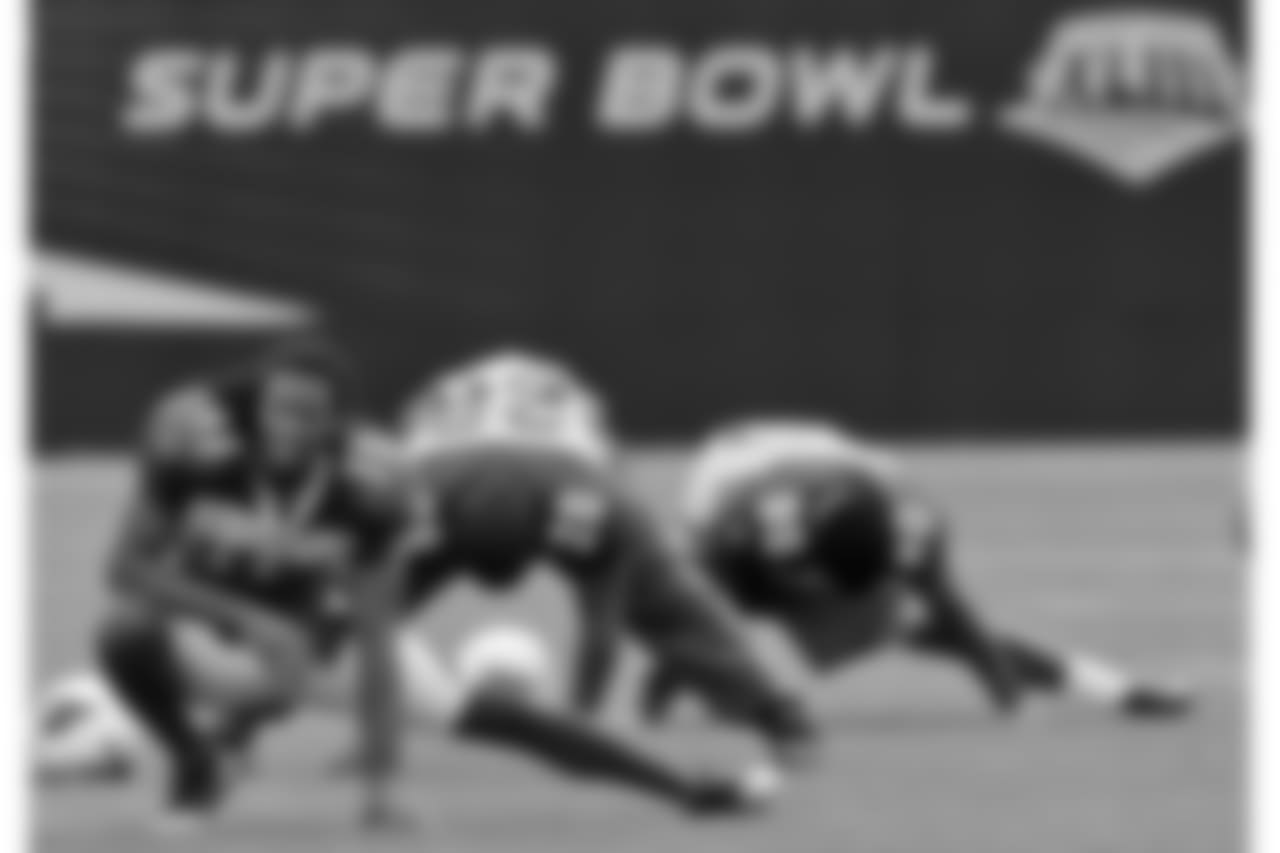 Stretching before a Super Bowl practice
