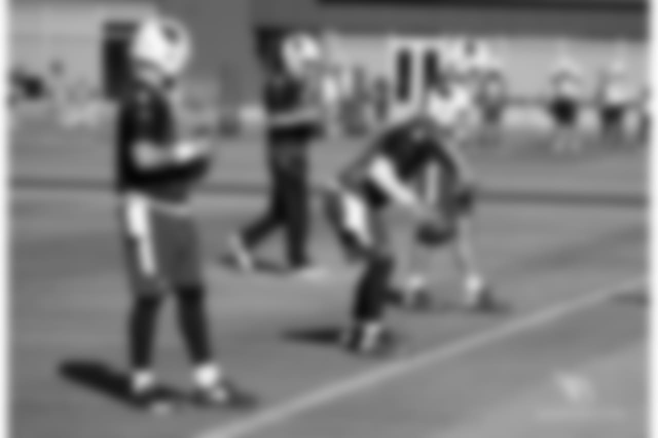 The quarterbacks work on their dropbacks