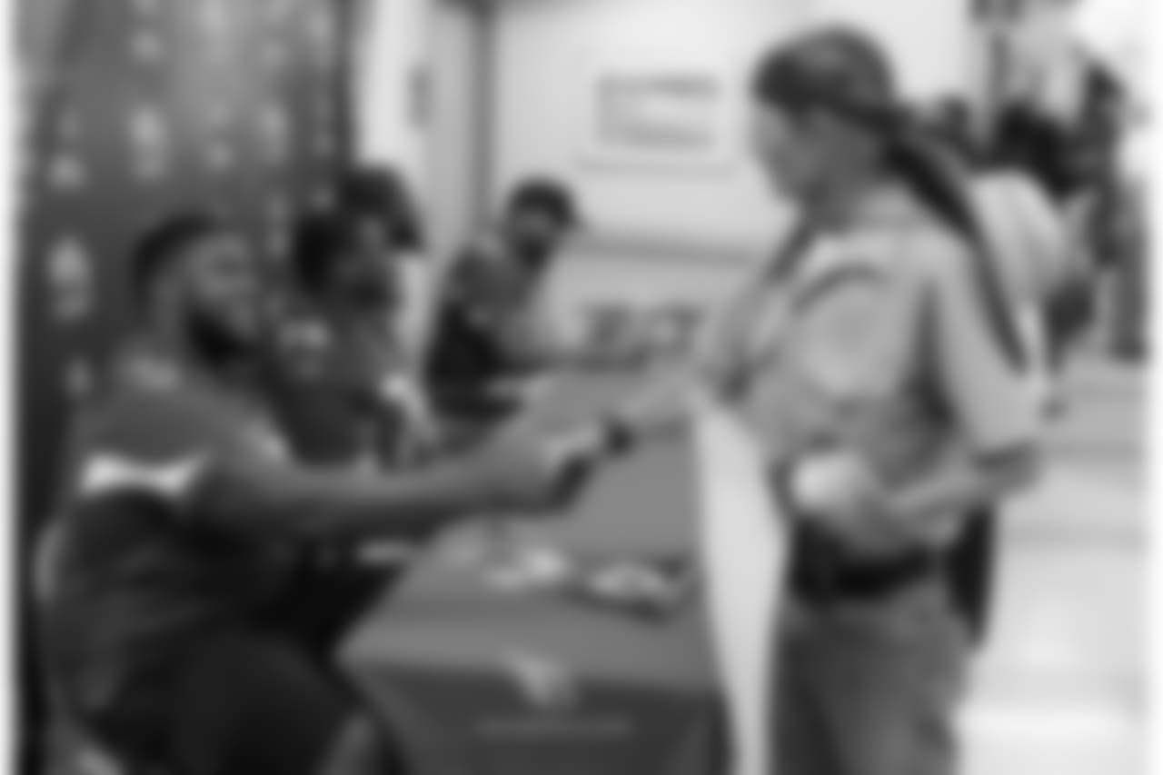 G Kaleb Johnson shakes the hand of a veteran