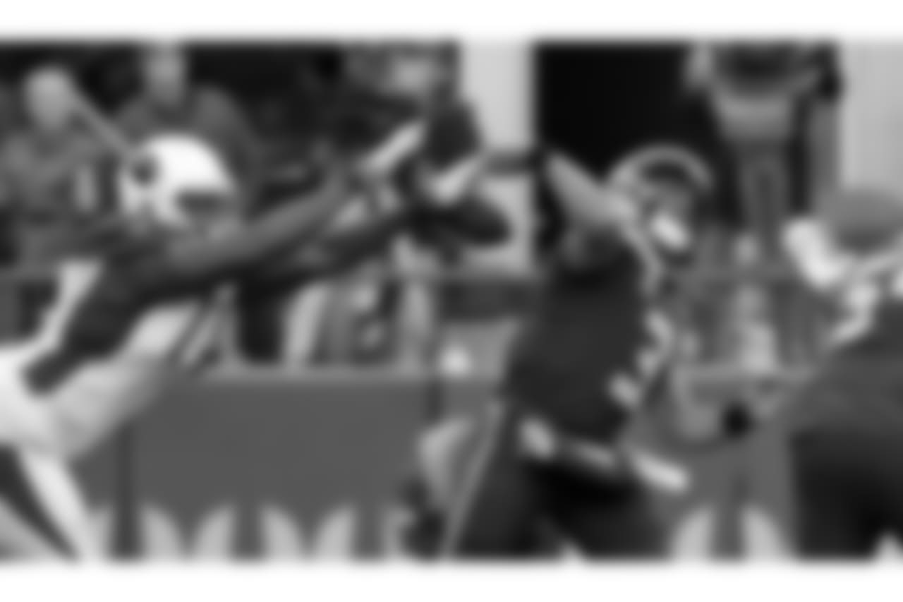 Cardinals DL Olsen Pierre knocks the ball away from Seahawks QB Russell Wilson