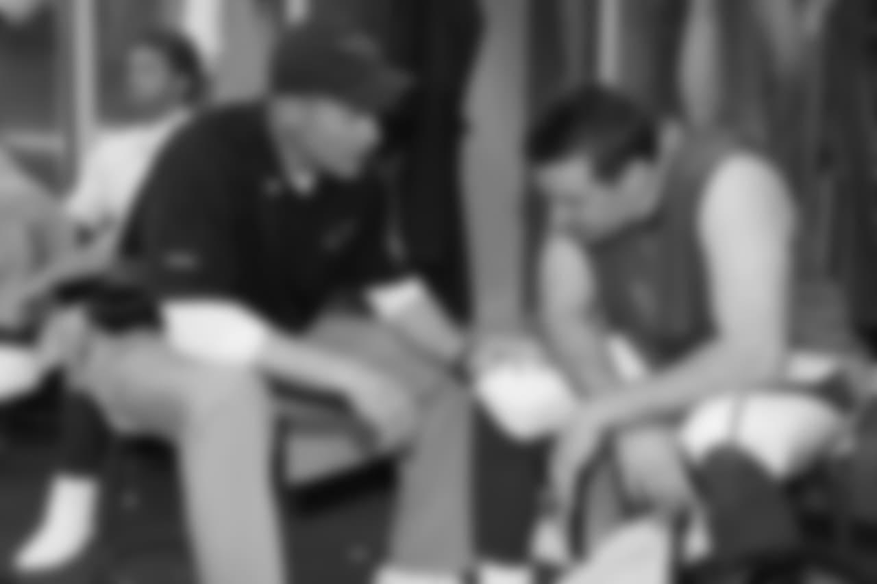 Coach Ken Whisenhunt and Warner talk in the locker room after what turned out to be Warner's last game at University of Phoenix Stadium