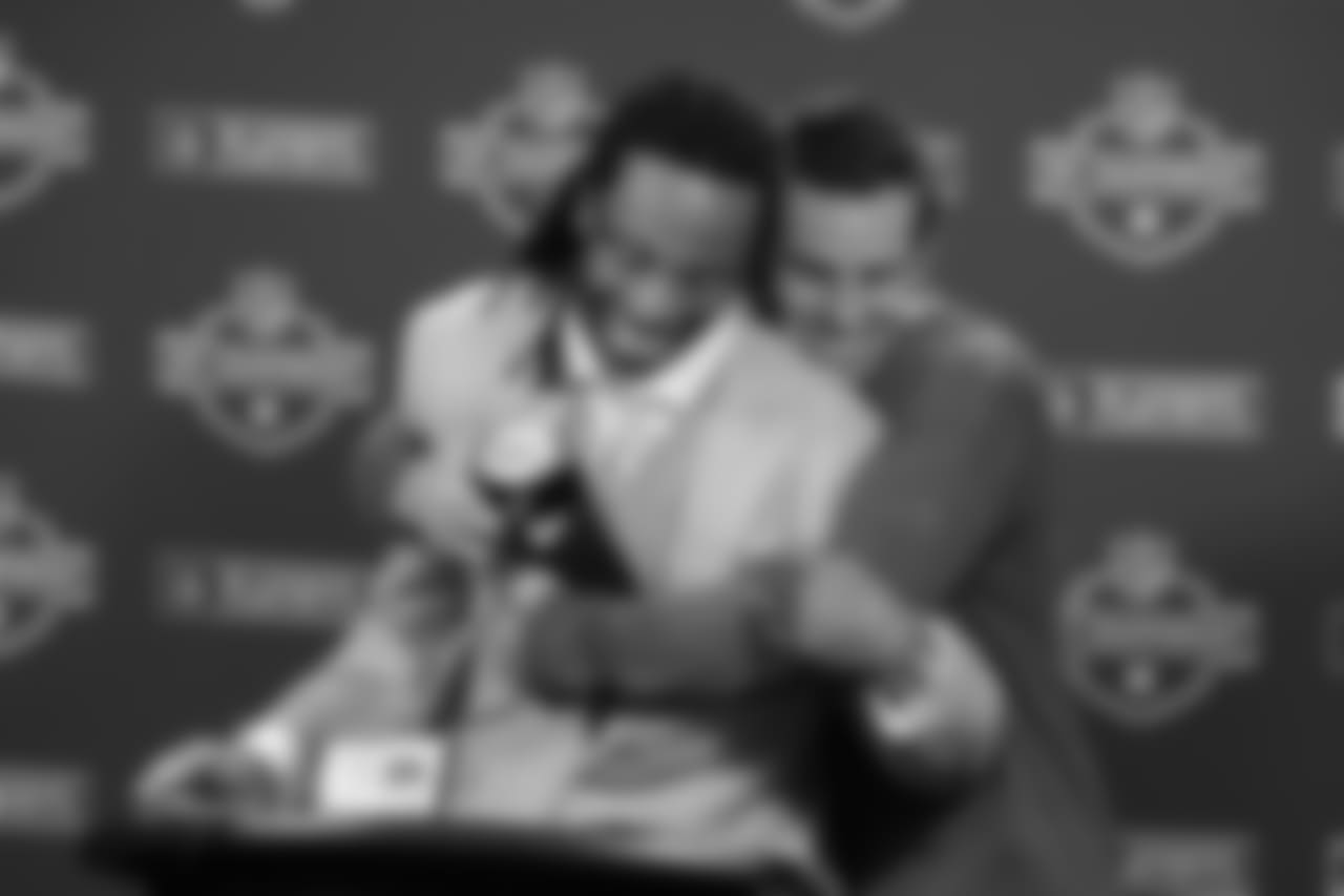 Warner with a big hug for WR Larry Fitzgerald at a press conference