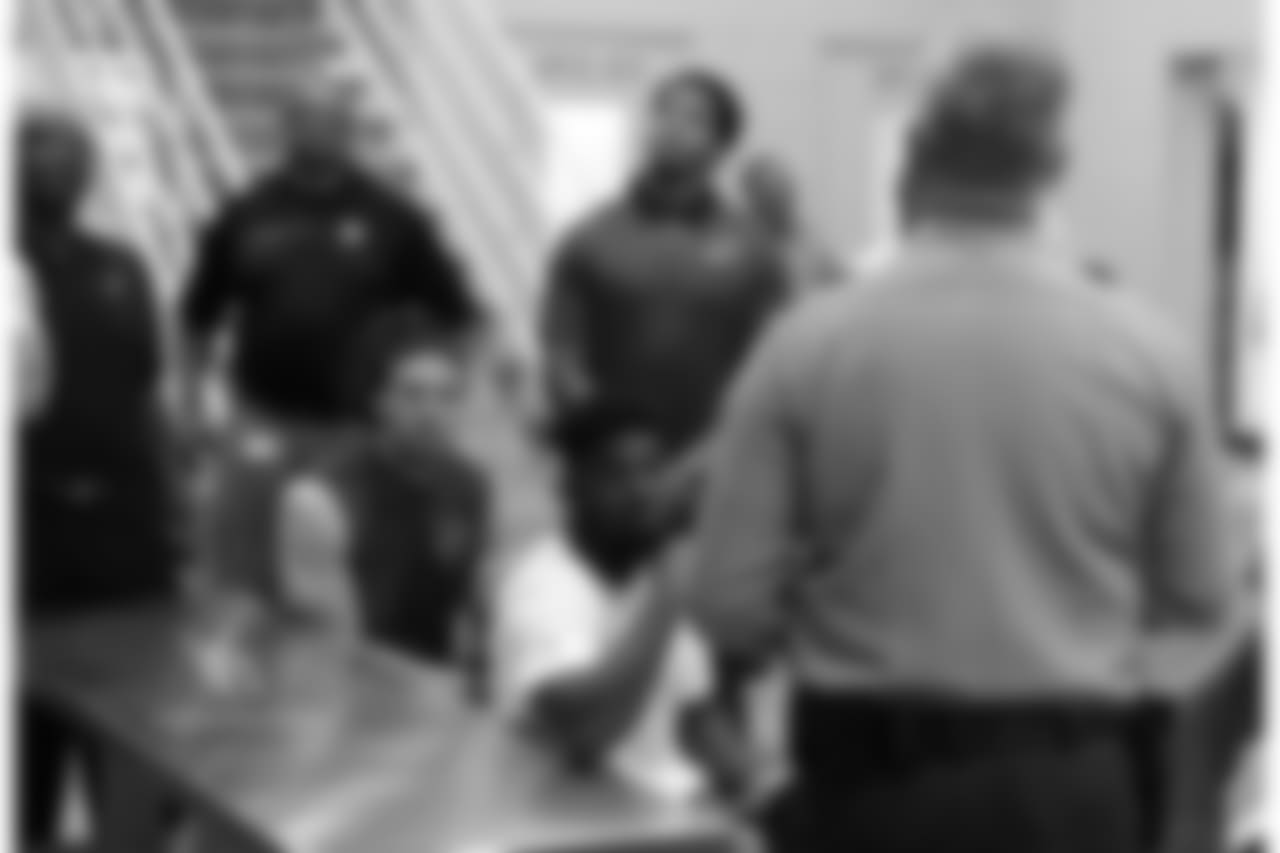 RB T.J. Logan (front) listens to information about the jail