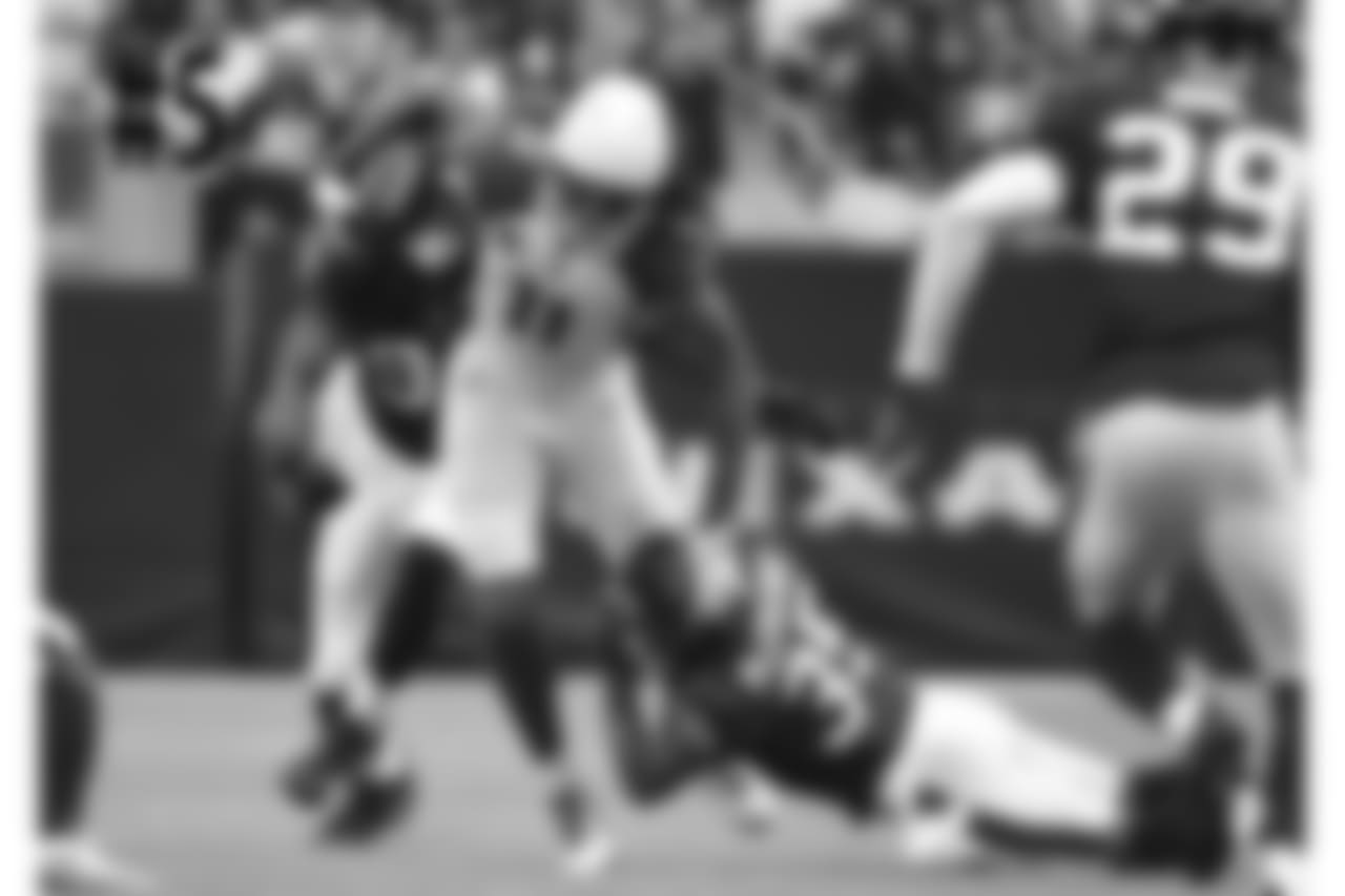WR Larry Fitzgerald fights for yardage