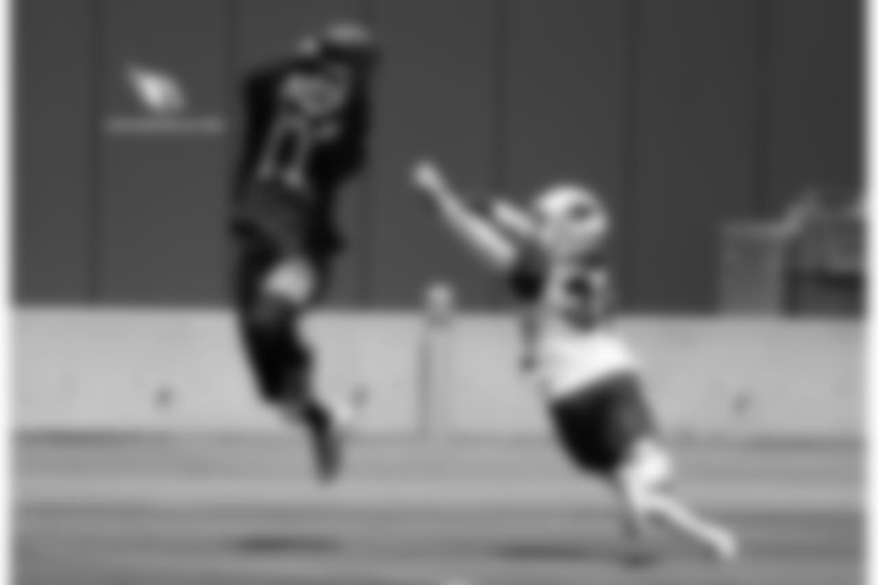 WR Larry Fitzgerald (left) catches a pass while S Budda Baker covers